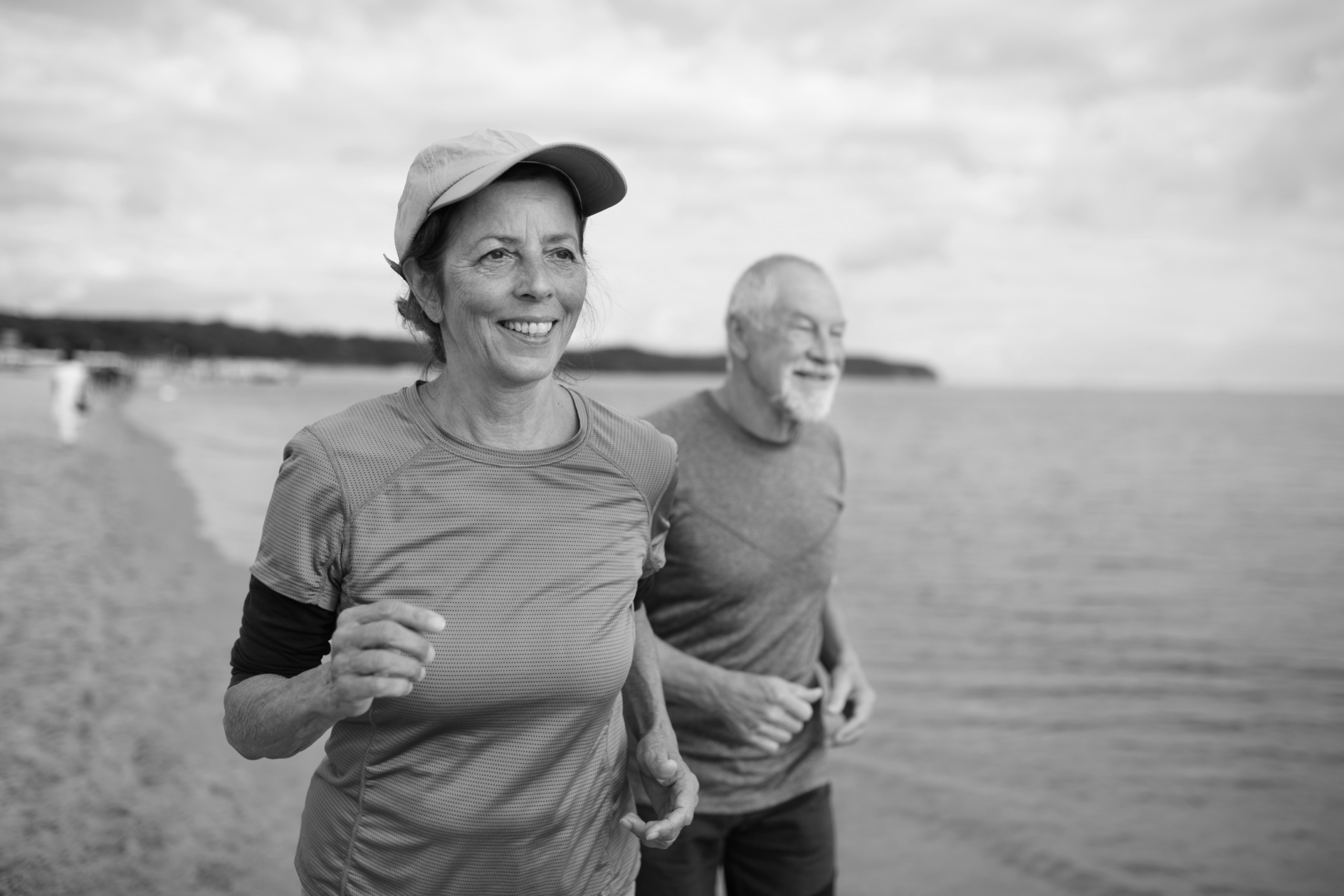 Older people jogging on a beach